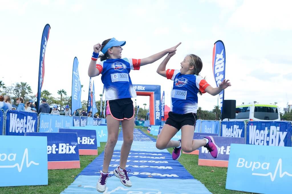 Blog photo - Weet-Bix kids Tryathlon where two kids are doing a high-five