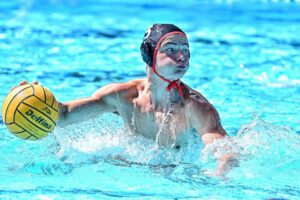 Photo of a water polo player holding the ball
